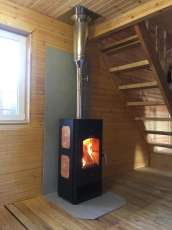 Популярный камин с дровницей Сибирь 8 в интерьере фото в Барановичах